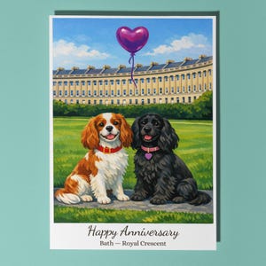May include: A greeting card with a painting of two dogs sitting on a grassy area in front of a building. A purple heart-shaped balloon floats above them. The card reads "Happy Anniversary" and "Bath - Royal Crescent."