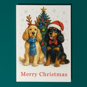 Puede incluir: Tarjeta de Navidad con dos perros. Uno lleva cuernos de reno y una bufanda azul, el otro un gorro de Papá Noel y una pajarita roja. Un árbol de Navidad decorado está entre ellos, con la frase "Merry Christmas" en la parte inferior.