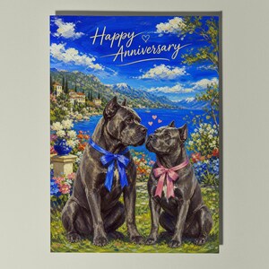 May include: A greeting card featuring an oil painting of two black Cane Corso dogs sitting in a garden by a lake. The left dog wears a blue bow, the right dog wears a pink bow. The text Happy Anniversary is written in white script at the top.