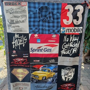 May include: A patchwork quilt made from fabric panels with text and graphics. It features a blue plaid shirt, racing logos, the number 33, and the text "No Way Get F*cked Off!" and "Vintage 1964".