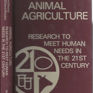 May include: A burgundy book cover with the title "Animal Agriculture: Research to Meet Human Needs in the 21st Century" in white text. The cover also features a white circle with a stylized image of a cow, a test tube, and a circle.