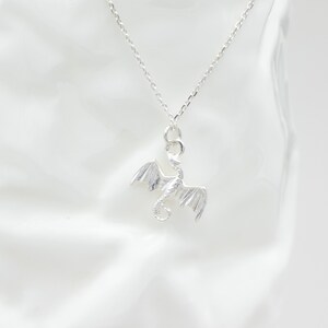 handcrafted sterling silver necklace with small flying dragon pendant on adjustable chain