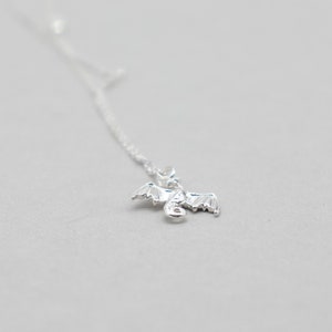 handcrafted sterling silver necklace with small flying dragon pendant on adjustable chain