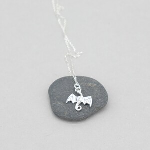 handcrafted sterling silver necklace with small flying dragon pendant on adjustable chain