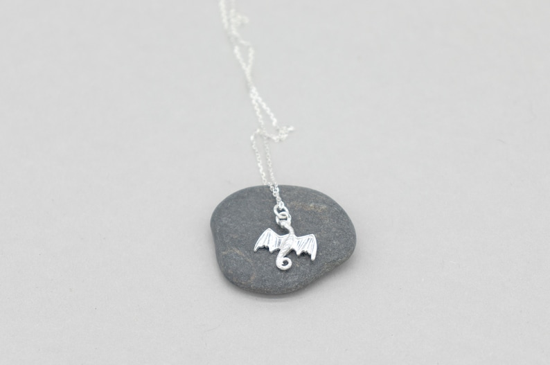 handcrafted sterling silver necklace with small flying dragon pendant on adjustable chain