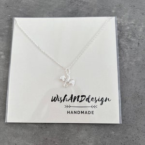 handcrafted sterling silver necklace with small flying dragon pendant on adjustable chain
