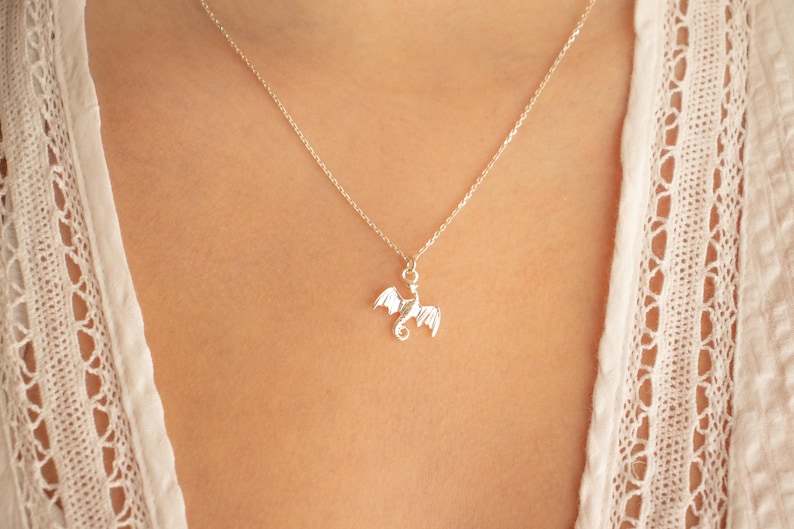 handcrafted sterling silver necklace with small flying dragon pendant on adjustable chain