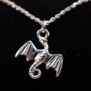 handcrafted sterling silver necklace with small flying dragon pendant on adjustable chain