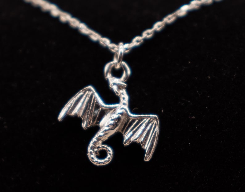 handcrafted sterling silver necklace with small flying dragon pendant on adjustable chain