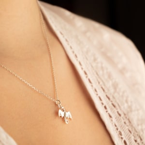 handcrafted sterling silver necklace with small flying dragon pendant on adjustable chain