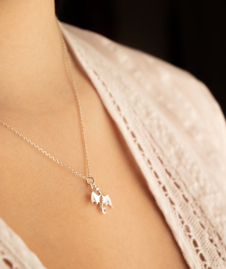 handcrafted sterling silver necklace with small flying dragon pendant on adjustable chain