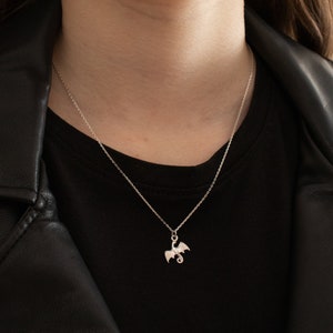 handcrafted sterling silver necklace with small flying dragon pendant on adjustable chain