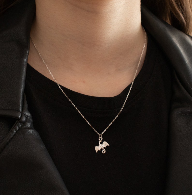 handcrafted sterling silver necklace with small flying dragon pendant on adjustable chain