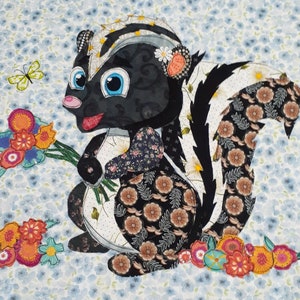 May include: A black and white appliqué of a skunk holding a bouquet of flowers. The skunk is surrounded by colorful flowers and leaves. The background is a light blue fabric with a floral pattern.