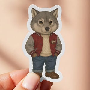 May include: A sticker featuring a cartoon wolf wearing a red and gray letterman jacket, a beige sweater, blue jeans, and brown boots. The wolf has gray fur and is standing with its hands in its pockets. The sticker has a white border.