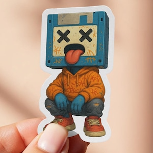 May include: A sticker featuring a squatting figure with a floppy disk for a head. The figure wears an orange hoodie, blue jeans, and red sneakers. The floppy disk head has crossed-out eyes and a sticking-out tongue.
