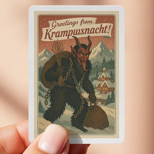 May include: A rectangular sticker featuring a vintage illustration of Krampus, a horned figure with a long tongue, carrying a sack and birch branches. The sticker has the text "Greetings from Krampusnacht!" in a vintage font, with a snowy mountain and village backdrop.