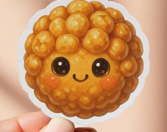 May include: A round sticker featuring a cartoon illustration of a smiling, golden-brown, textured food item with rosy cheeks and black eyes. The sticker has a white border and is held by a hand against a soft pink background.