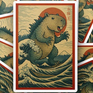 May include: A sticker featuring a capybara-like creature with a spiky back, standing on a wave with a mountain backdrop and a red sun. The Japanese text "Water King" is above the capybara. The sticker has a red border.