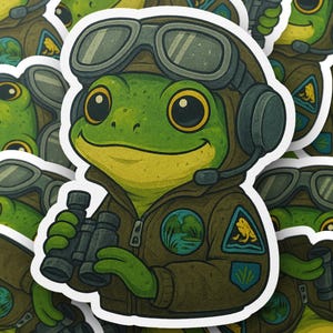 May include: A sticker featuring a cartoon frog wearing a pilot's uniform, including a brown jacket, aviator goggles, and a headset. The frog is holding binoculars and has a friendly expression. The sticker has a white border and a cartoon style.