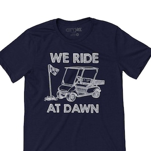 We Ride at Dawn Golf Shirt – Funny Golf T-Shirt for Dad, Grandpa, or Husband – Golf Cart Shirt – Golf Gift for Father's Day or Birthday