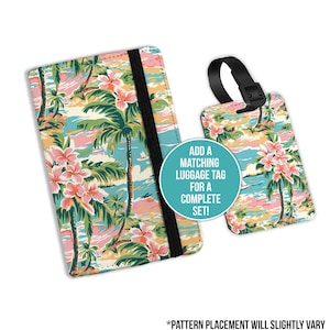 May include: A passport holder and matching luggage tag with a tropical print featuring palm trees, pink flowers, and a blue ocean. The text "ADD A MATCHING LUGGAGE TAG FOR A COMPLETE SET!" is printed on the luggage tag. The text "*PATTERN PLACEMENT WILL SLIGHTLY VARY" is printed below the image.
