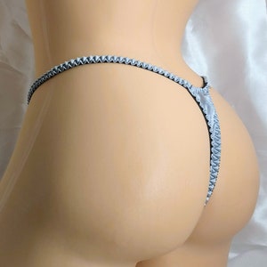 May include: A silver satin lingerie with a scalloped edge.