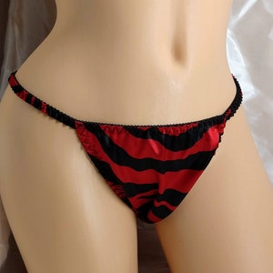 May include: Red and black striped satin lingerie with a low-rise cut and a delicate trim.