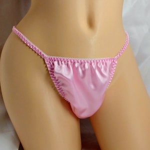 May include: Pink satin lingerie with white trim. The lingerie has a low rise and a cheeky cut.
