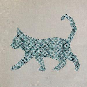 May include: A teal blue geometric cat silhouette embroidered on a white canvas. The cat is walking with its tail curled up.