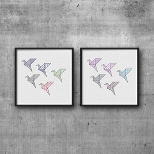 May include: Two framed prints of origami birds in various colors and patterns. Each print features six birds in a symmetrical arrangement.