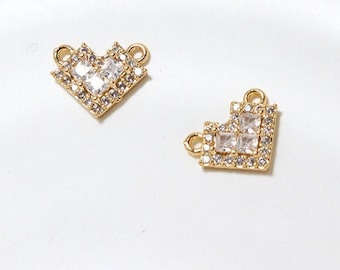 May include: Two gold-tone heart-shaped charms with clear crystal accents. The charms have a loop on each side for attaching to jewelry.