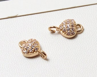 May include: Two gold-tone heart-shaped charms with clear crystal embellishments. Each charm has a loop on the side and a small loop on the top.