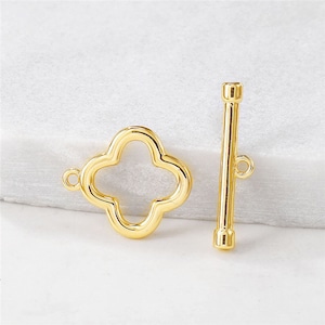 May include: Gold-toned metal clasp with a four-leaf clover design and a straight bar closure. This is a jewellery finding for making necklaces, bracelets, and other jewellery.