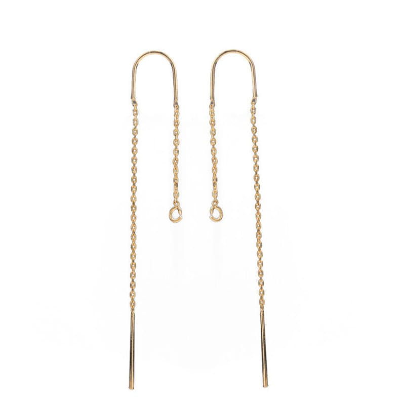 May include: A pair of gold-toned earring findings with a chain and a small loop at the top. The chain is about 2 inches long and has a small, straight piece at the bottom.