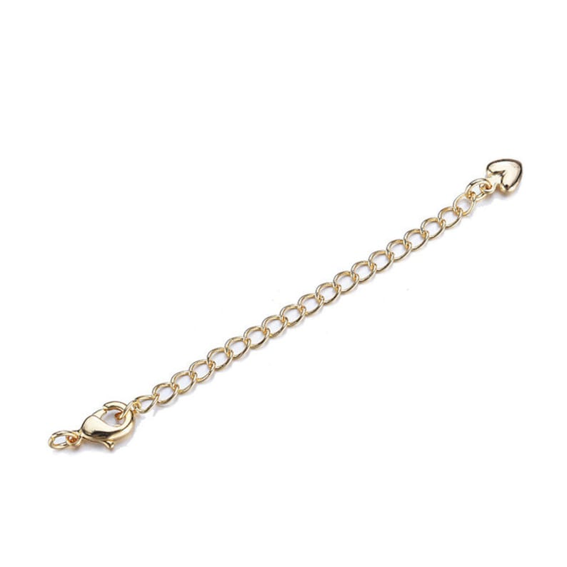 May include: A gold chain extender with a lobster clasp on one end and a heart-shaped connector on the other end.