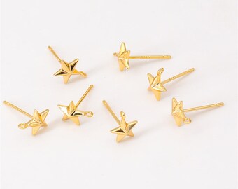 May include: Six gold-toned star-shaped earring findings with a loop on the top and a post on the bottom. The findings are on a white background.