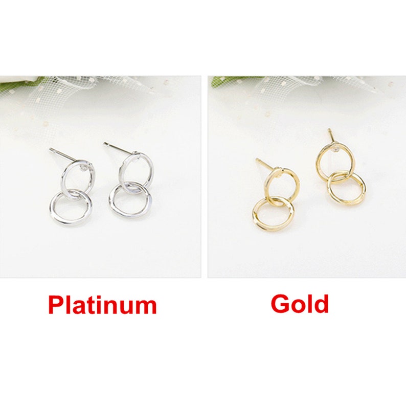 May include: Two pairs of double circle earrings, one pair in silver and one pair in gold.