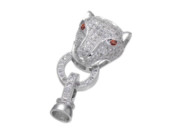 May include: Silver-toned panther head clasp with clear and red cubic zirconia stones. The clasp is designed to be used for necklaces or bracelets.