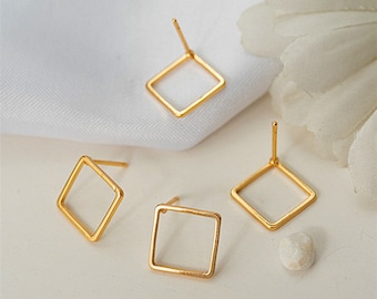 May include: Three gold square earring blanks with posts. The earring blanks are on a white surface.