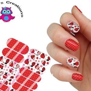 May include: Nail wraps with a red and white polka dot pattern and a design of ladybugs with hearts on a white background.