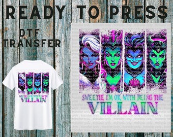 May include: White t-shirt with a DTF transfer featuring a colorful design of villainous characters. The text "SWEETIE I'M OK WITH BEING THE VILLAIN" is printed below the characters. The words "READY TO PRESS" and "DTF TRANSFER" are printed above the t-shirt.