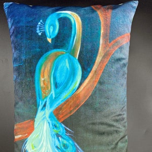 May include: A blue and green peacock with its tail feathers spread out on a dark blue background. The peacock is perched on a branch with orange and brown accents. The pillow is made of soft, plush fabric.