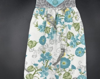 Hanging Hand Towel is Smooth White Cotton Terry Covered with Turquoise Flowers with Turquoise and Grey Cottons and Turquoise Button Closure