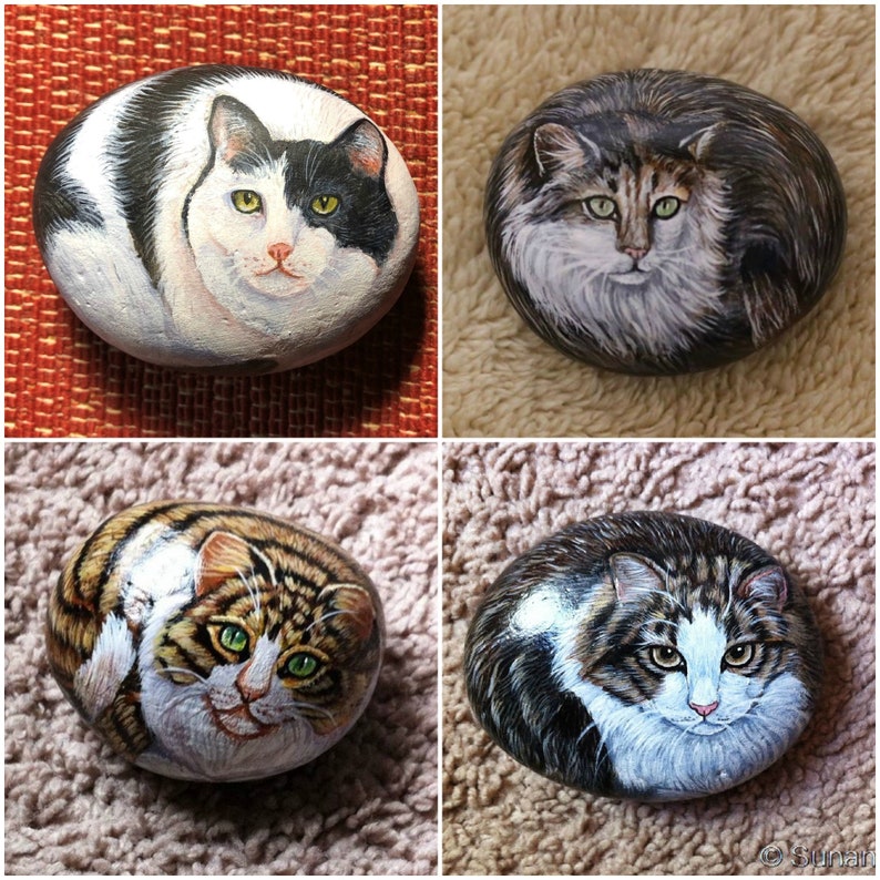 May include: Four painted rocks with different cat designs. The rocks are oval shaped and painted with realistic details. The cats are a black and white cat, a brown tabby cat, a gray and white cat, and a brown and white cat.