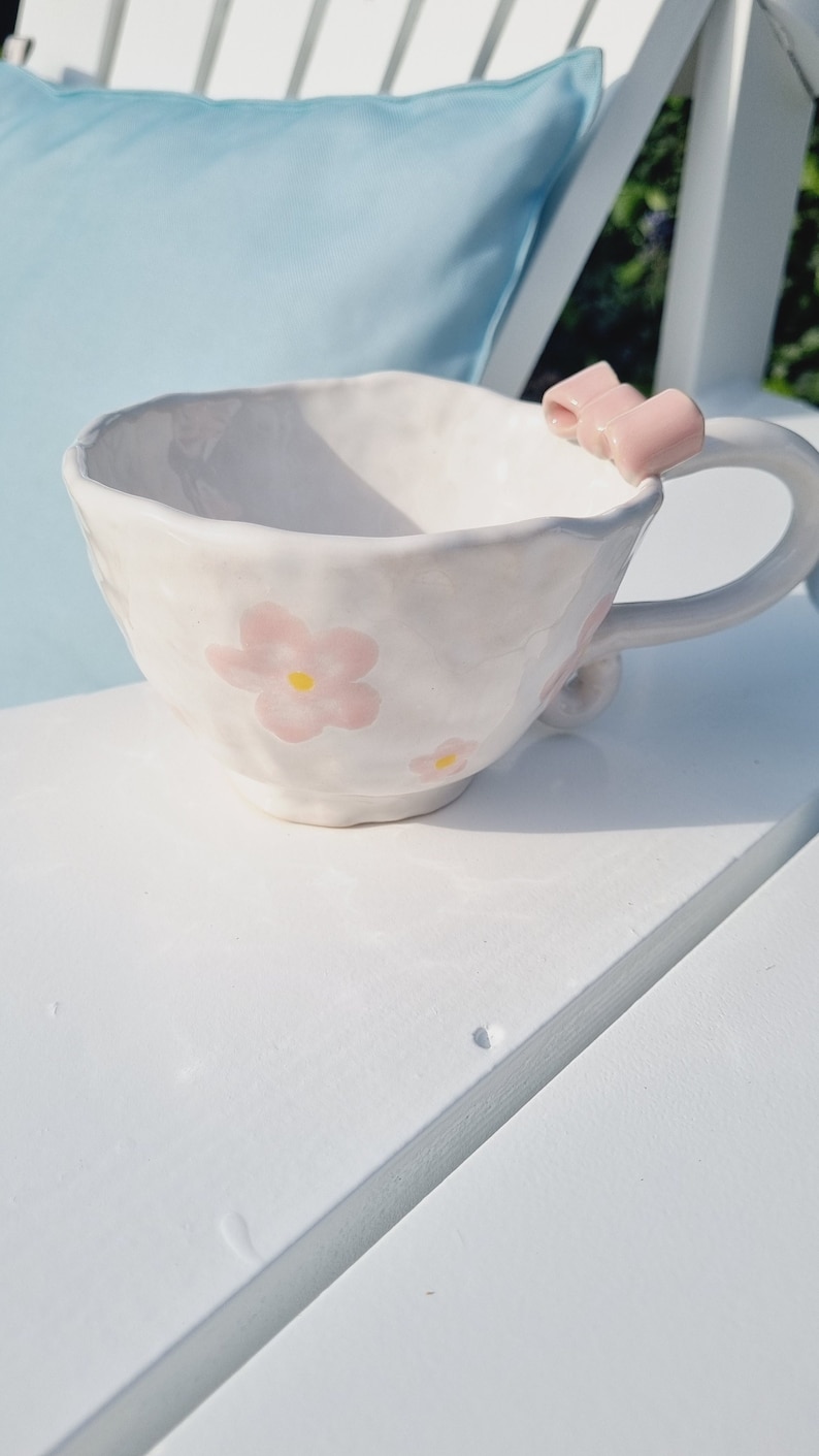 Handpinched mug with pink ceramic bow. Handpainted with pink flowers. Cute girly mug. Vintage handle