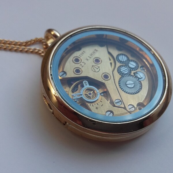 Pendant created from a vintage watch movement under glass