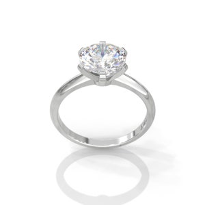 Pu&ograve; includere: Un anello di fidanzamento in argento con un grande diamante rotondo trasparente incastonato in una montatura a sei griffe.
