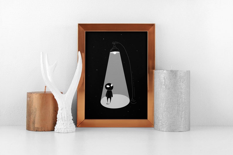 May include: A framed black and white illustration of a small figure standing in a spotlight against a starry night background.