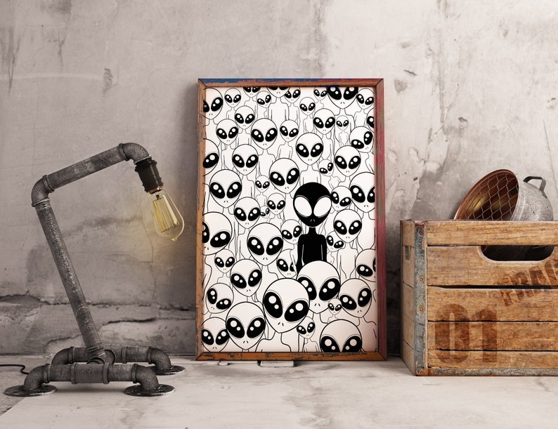 May include: Black and white print of a crowd of aliens with one alien standing out in the middle. The print is framed in a black frame with a white mat.
